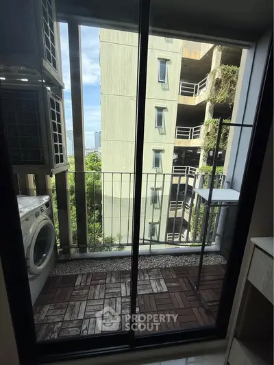 Charming balcony with laundry area and city view, perfect for urban living.