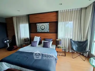 Modern bedroom with stylish decor and large windows for natural light