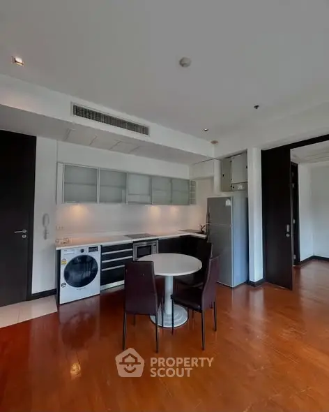 Modern kitchen with sleek appliances and dining area in a stylish apartment