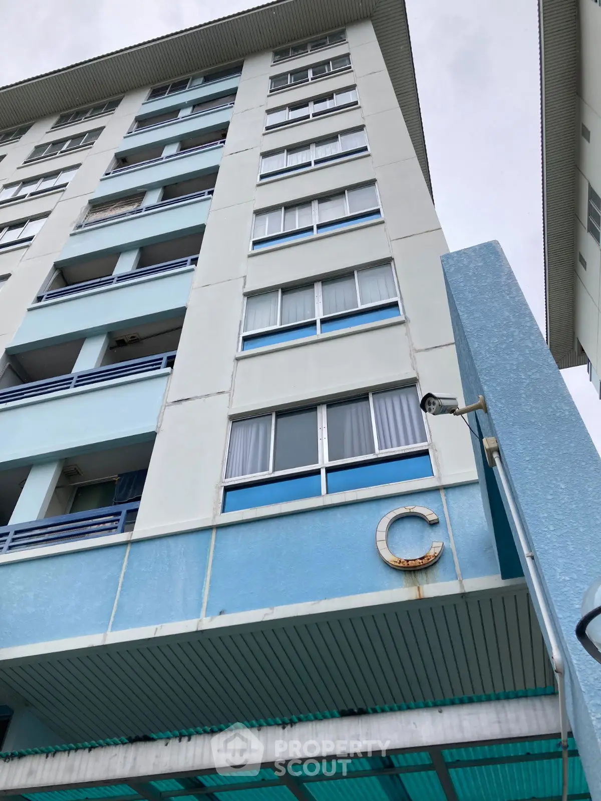 High-rise residential building exterior with blue accents and multiple windows