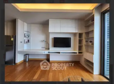 Modern living room with built-in shelves and wooden flooring