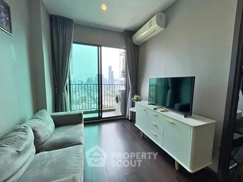 Modern living room with city view, featuring sleek furniture and large windows for natural light.