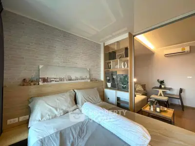 Modern bedroom with cozy decor and adjacent living area in stylish apartment.