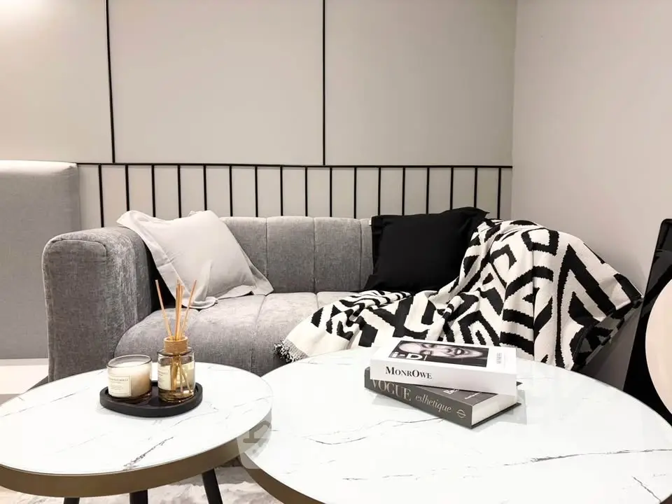 Stylish modern living room with cozy gray sofa and chic decor