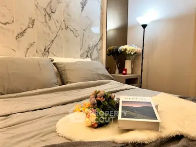 Luxurious bedroom with elegant marble accent wall and cozy lighting, perfect for relaxation.