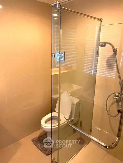 Modern bathroom with glass shower enclosure and sleek fixtures