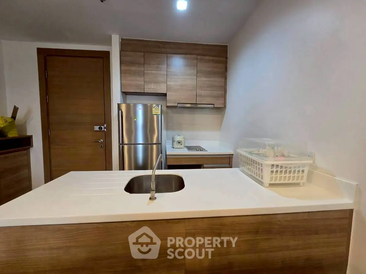 Modern kitchen with sleek wooden cabinets and stainless steel appliances