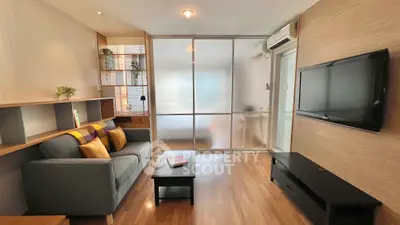 Modern living room with sleek design, featuring a cozy sofa, wall-mounted TV, and stylish partition.