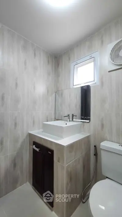 Modern bathroom with sleek sink and toilet in minimalist design