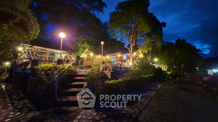 Charming evening view of a beautifully lit garden and house exterior