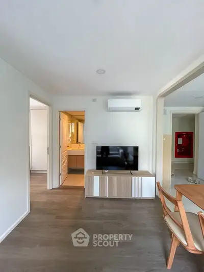 Modern living room with sleek furniture and air conditioning, showcasing a stylish and comfortable interior design.