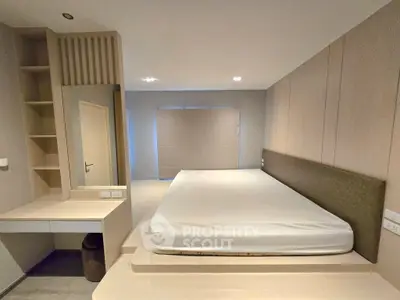 Spacious modern bedroom with minimalist design and built-in storage solutions.