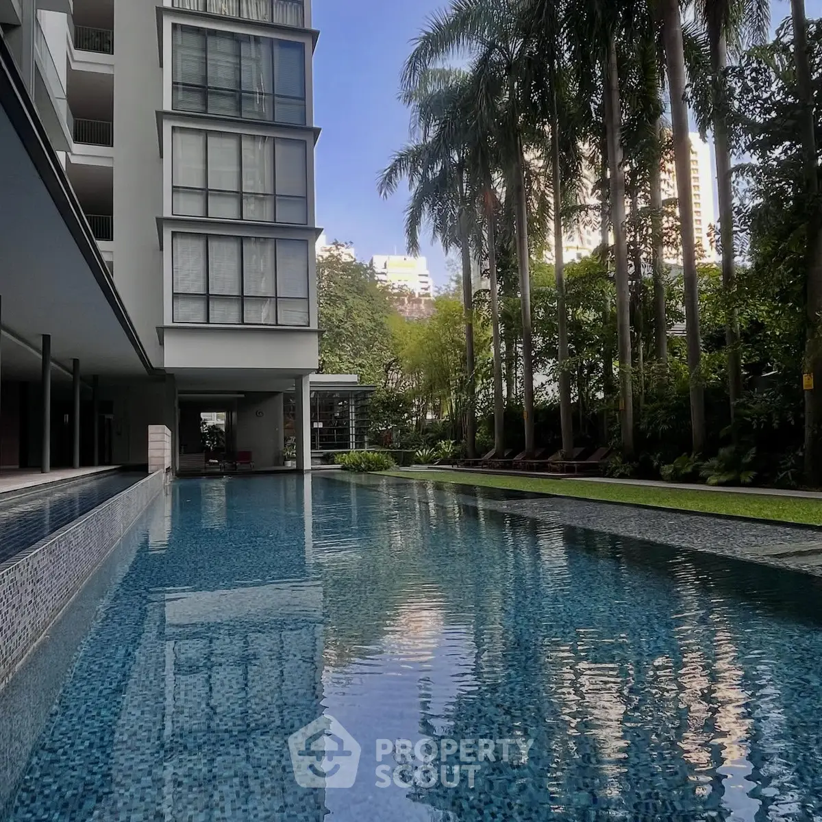 Luxurious condominium with stunning pool and lush garden view
