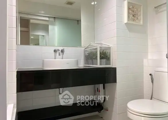 Modern bathroom with sleek black vanity and white tiles