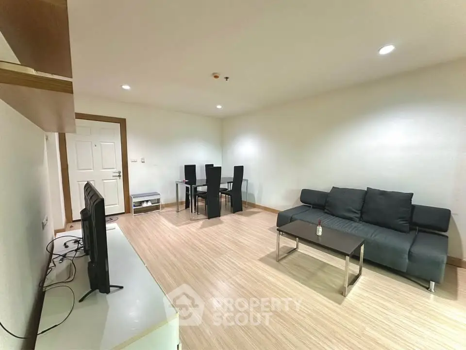 Spacious modern living room with sleek furniture and dining area, perfect for urban living.