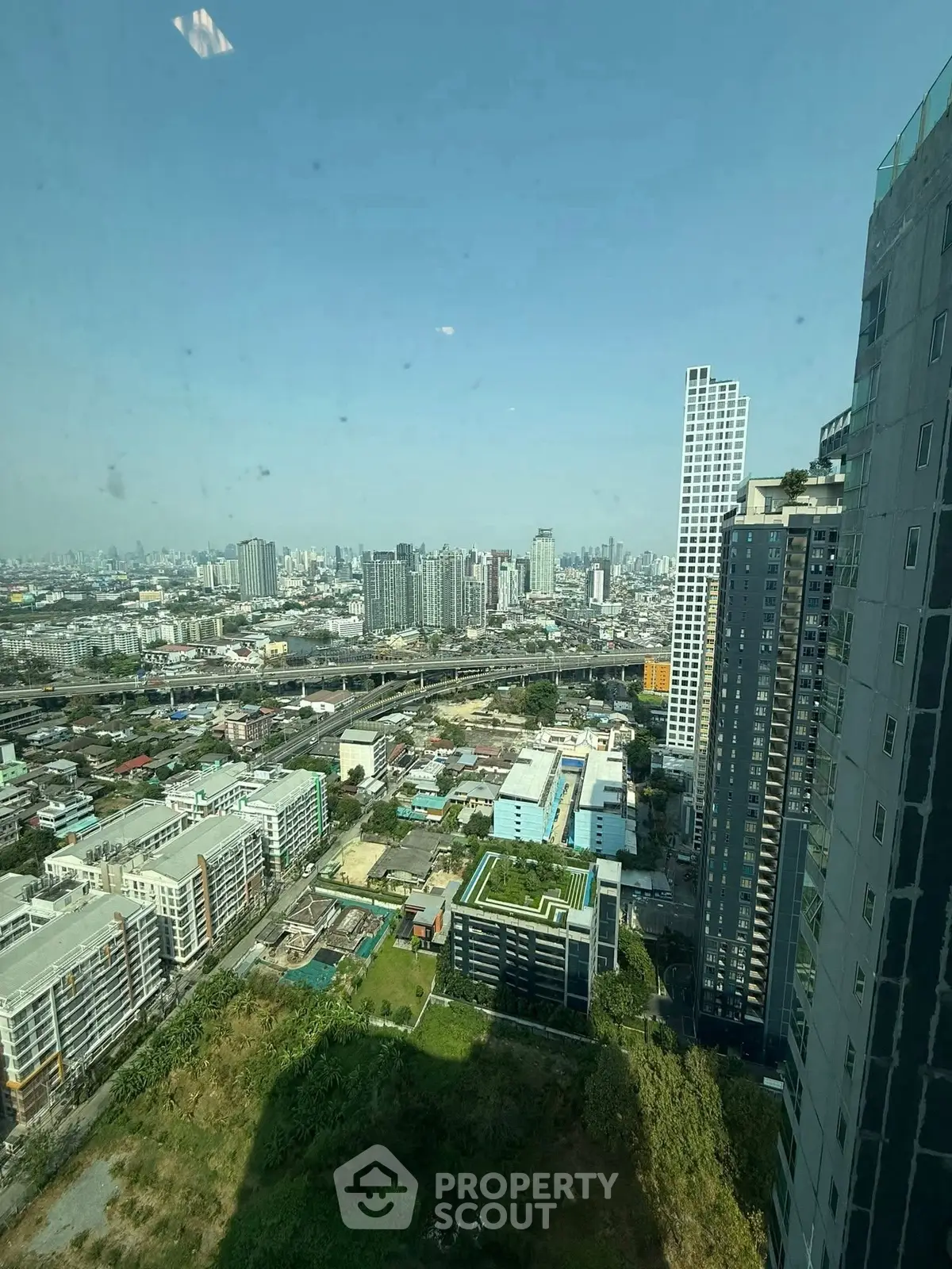 Stunning cityscape view from high-rise building showcasing urban skyline and modern architecture.