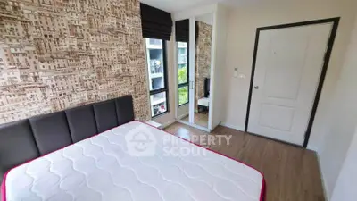 Modern bedroom with stylish wallpaper and mirrored wardrobe