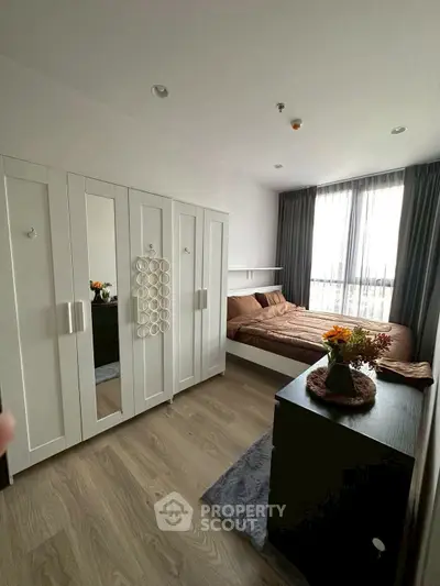 Modern bedroom with stylish decor and ample natural light