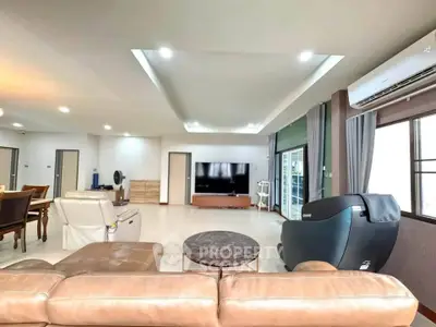 Spacious modern living room with luxurious seating and entertainment center