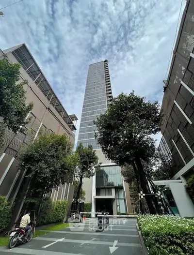 Stunning high-rise building with lush greenery and modern architecture.