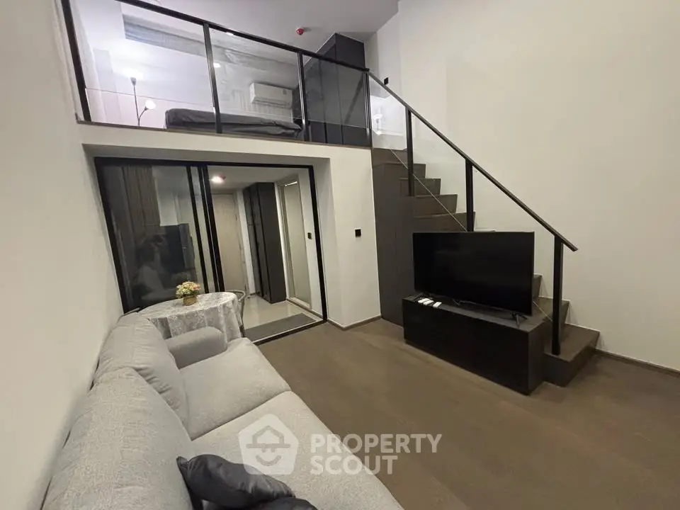 Modern loft-style living room with mezzanine bedroom and sleek interior design.