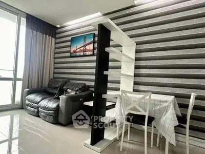 Modern living room with stylish decor and natural light, featuring a cozy sofa and dining area.
