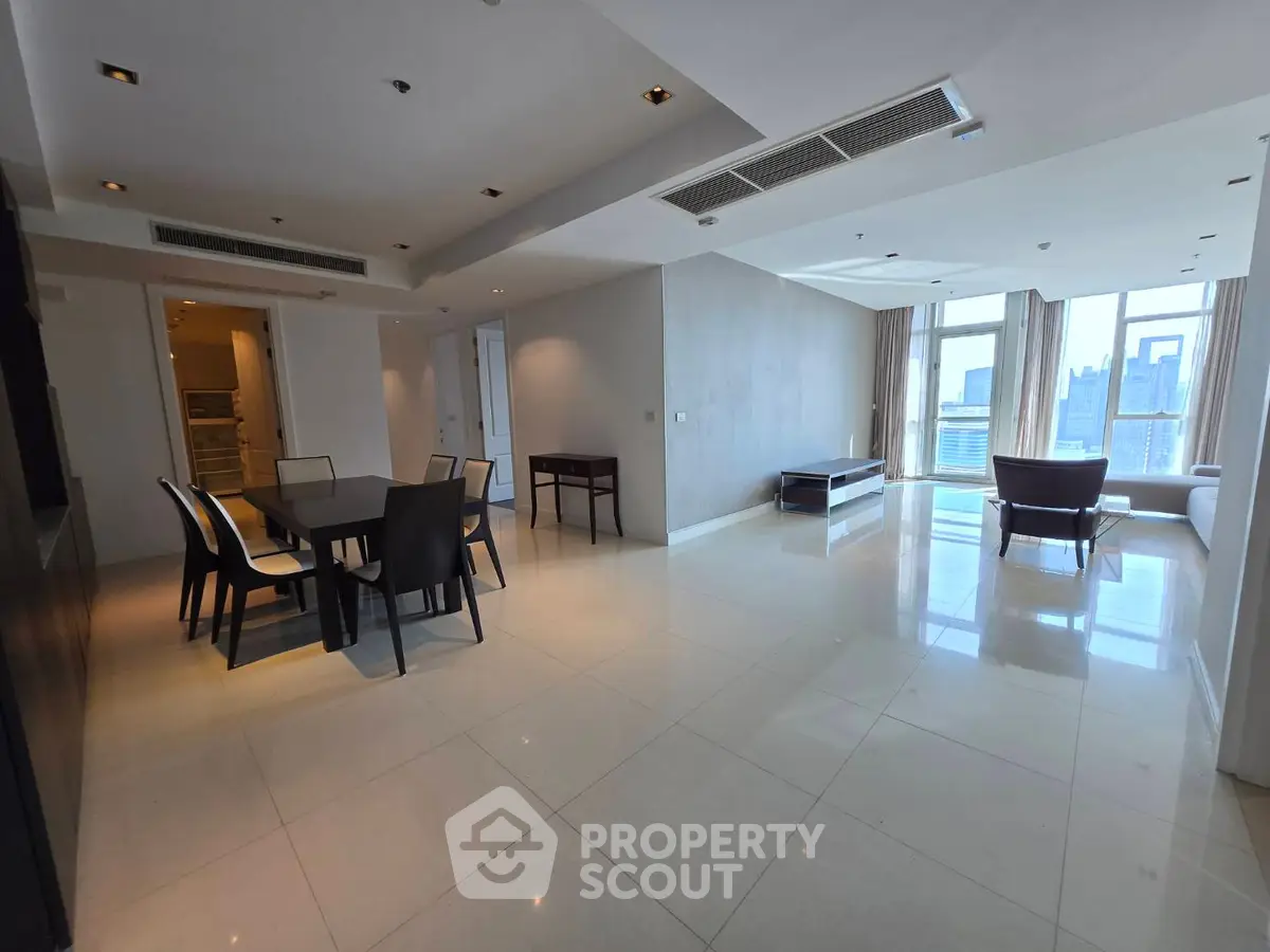 Spacious modern living room with city view and elegant dining area