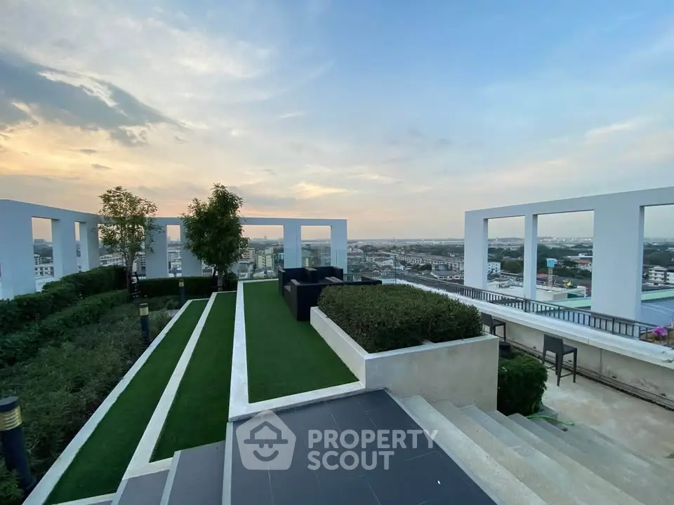 Stunning rooftop garden with panoramic city views at sunset, perfect for relaxation and entertainment.