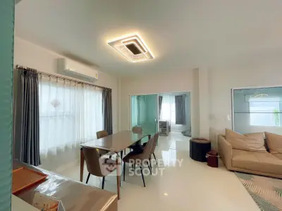 Spacious modern living room with dining area and stylish lighting