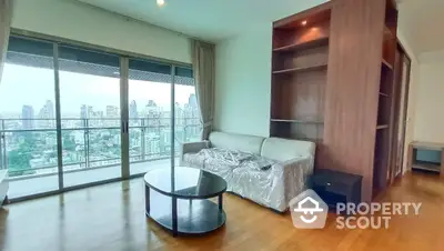 Spacious high-rise living room with panoramic city views, hardwood floors, and modern furniture, ideal for urban living.