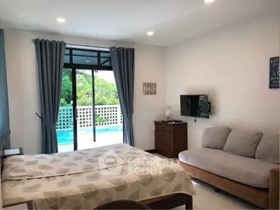 Spacious bedroom with pool view and modern decor