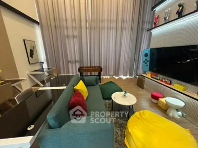 Stylish living room with modern decor and entertainment setup, featuring colorful seating and a large TV.