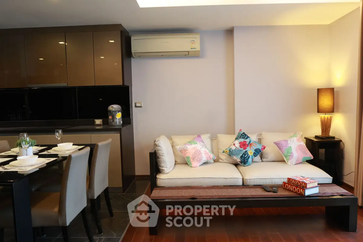 Modern living room with stylish decor and dining area in open layout apartment.