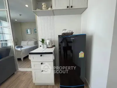 Charming studio apartment with modern kitchenette and cozy bedroom, perfect for urban living.