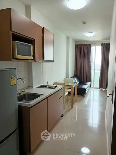 Modern compact kitchen with open layout and cozy living area