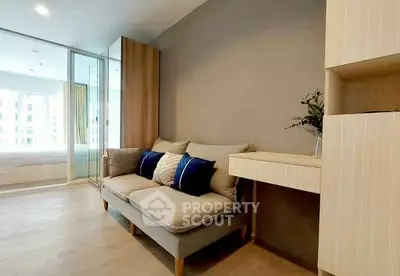 Modern living room with cozy sofa and stylish decor in a bright apartment.