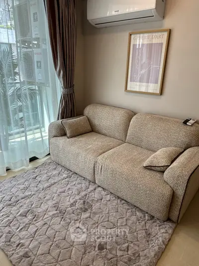 Cozy living room with plush sofa and elegant decor, perfect for relaxation.