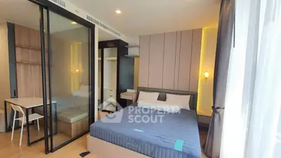 Modern bedroom with glass partition and stylish decor