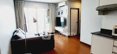 Modern living room with sleek design, featuring a cozy sofa, wall-mounted TV, and natural light from large windows.