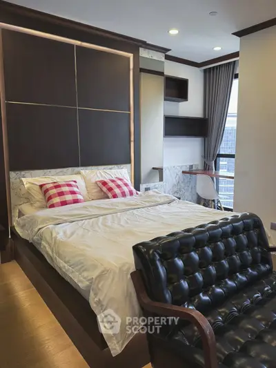 Luxurious bedroom with modern decor and city view, featuring elegant furniture and stylish design.