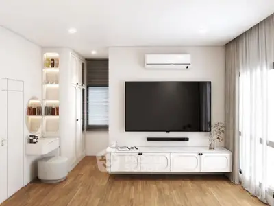 Modern living room with large TV, wooden flooring, and elegant decor