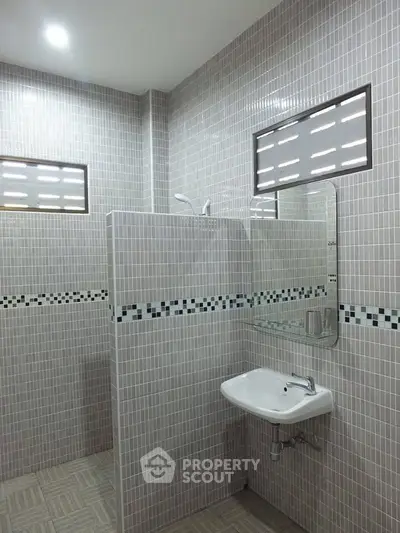 Modern bathroom with tiled walls and sleek sink design