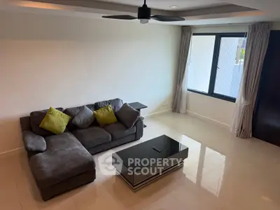 Spacious living room with modern sofa and large window for natural light.