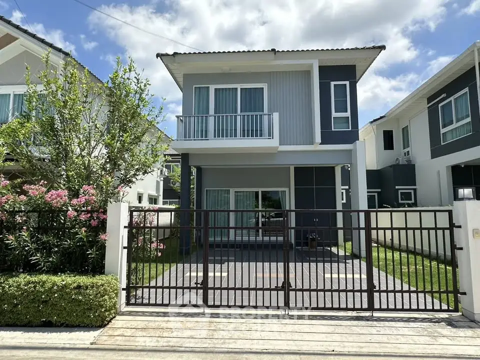 Modern two-story house with a sleek design and spacious driveway in a serene neighborhood.