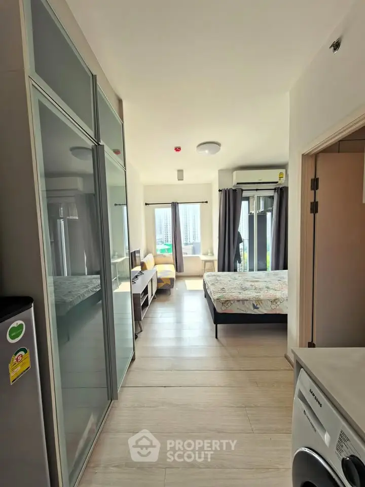 Modern studio apartment with natural light and sleek furnishings