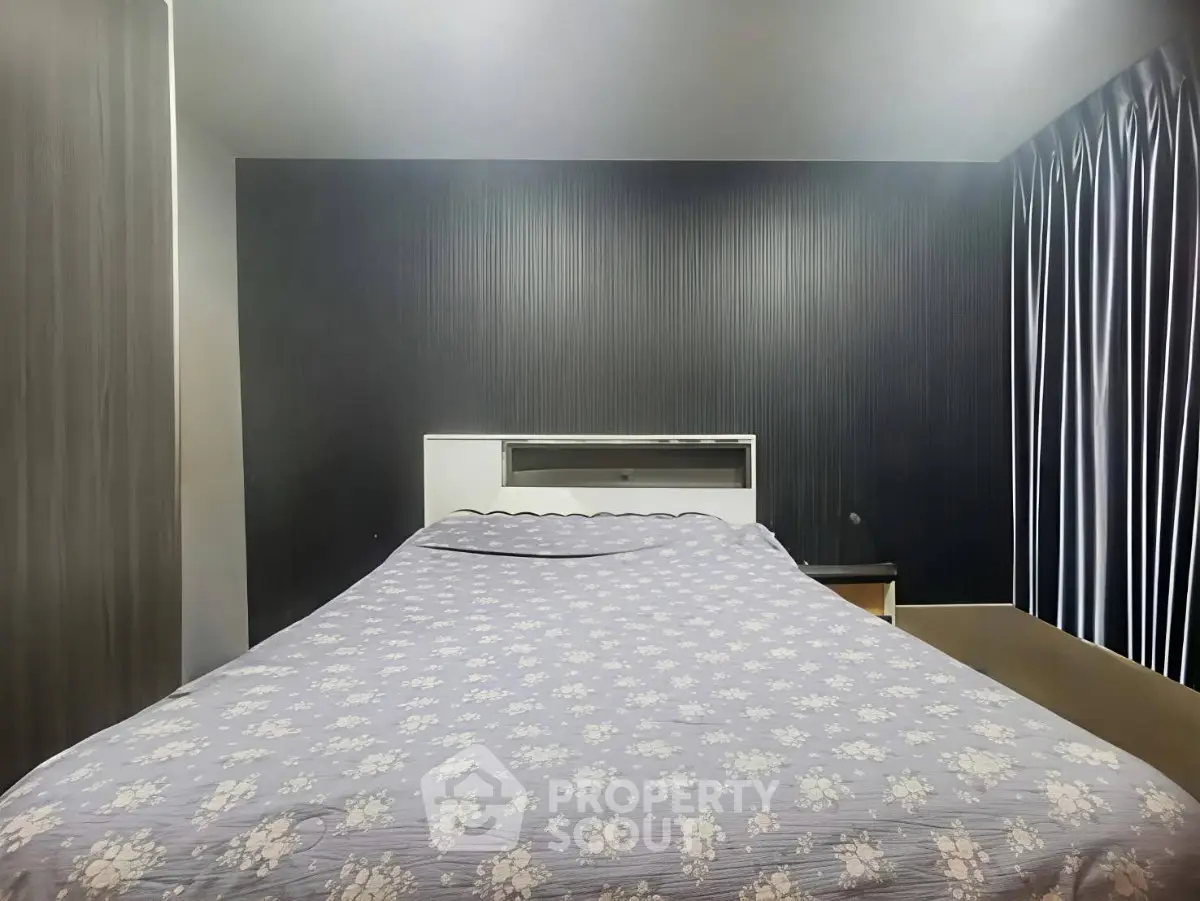 Cozy bedroom with modern decor and stylish curtains, perfect for relaxation.