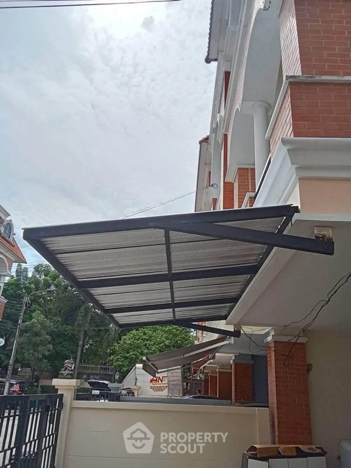 Modern building exterior with stylish awning and brick facade