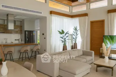 Luxurious open-plan living room with modern kitchen and elegant decor