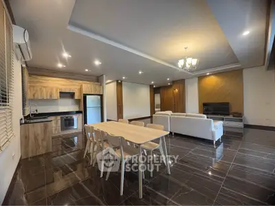 Spacious modern living room with open kitchen, elegant dining area, and stylish decor.