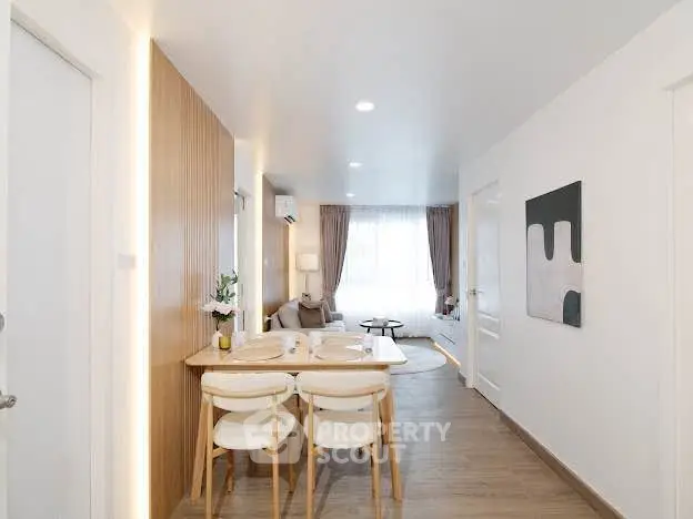 Modern open-plan living and dining area with stylish decor and natural light.